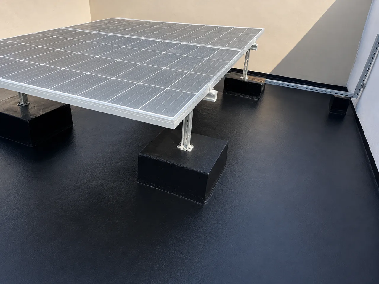 Finished waterproofed rooftop beneath installed solar panels